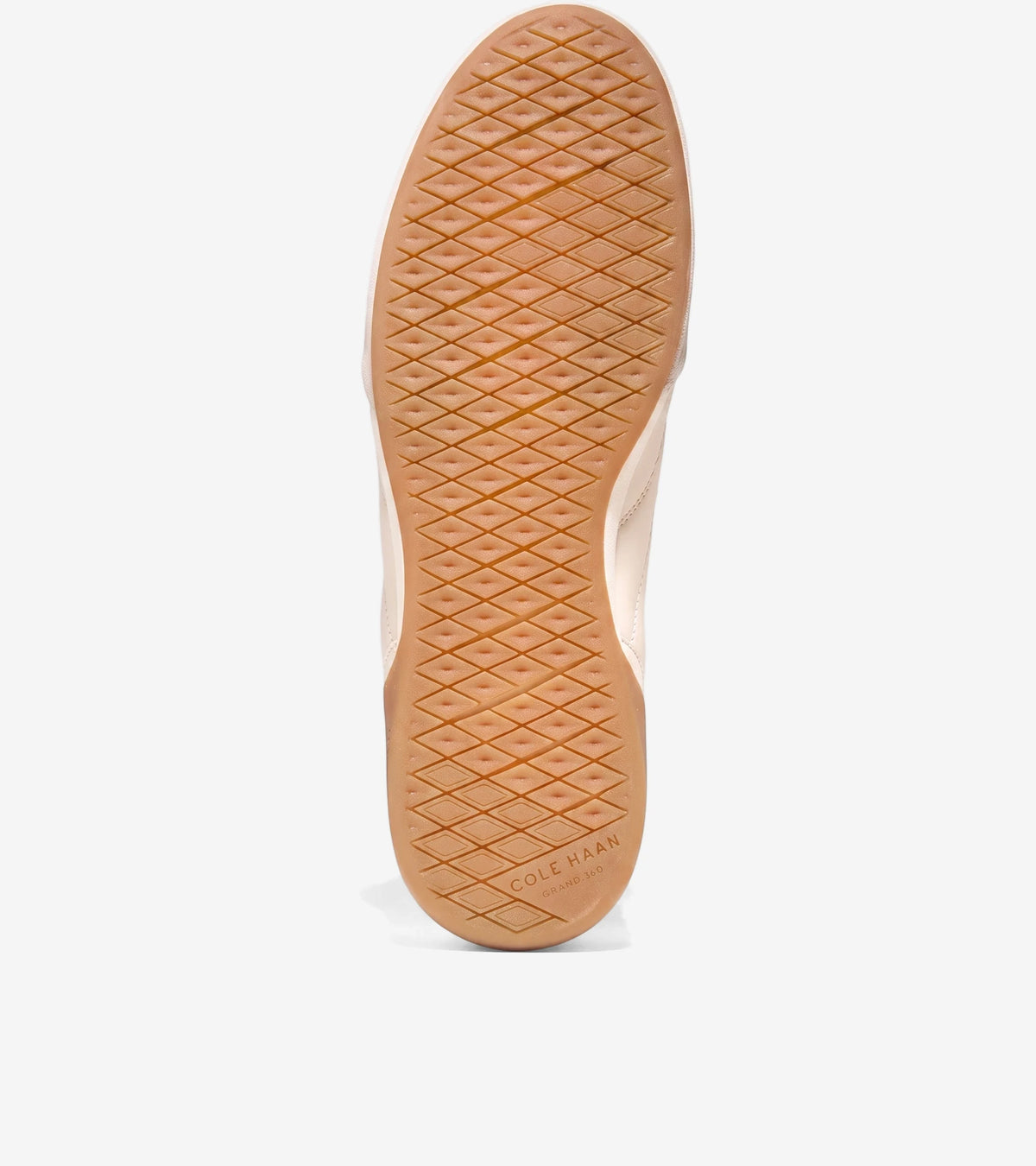 Underside view of a Cole Haan Grandpro Turf 2.0 shoe, showcasing its light brown diamond-patterned sole and ivory upper.
