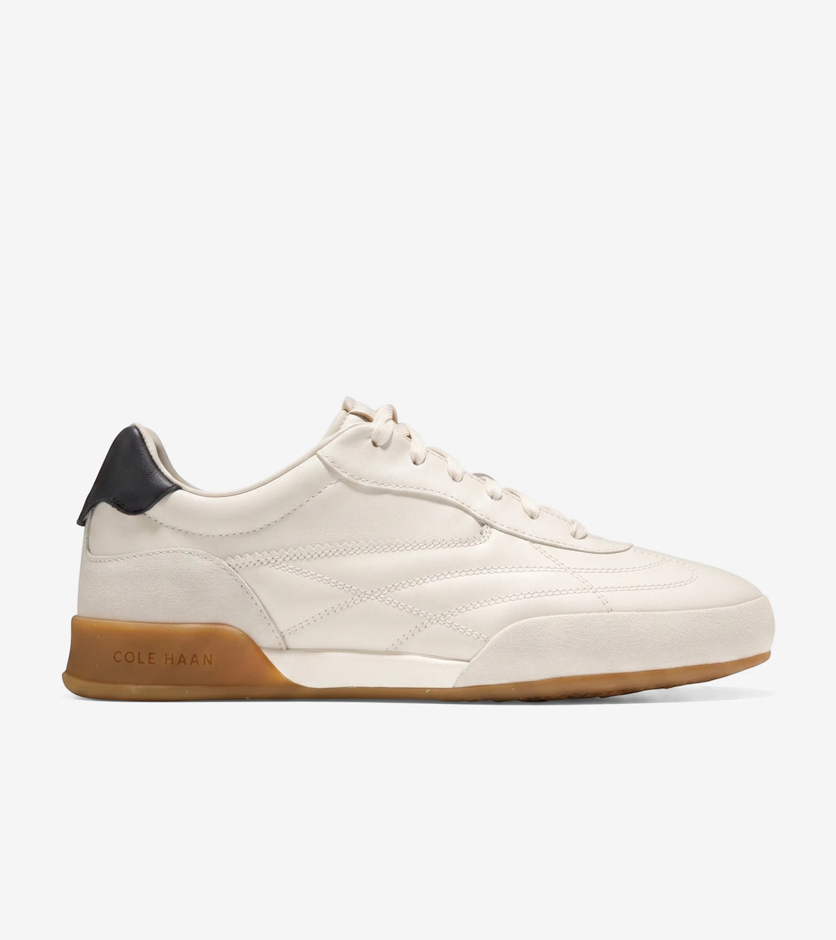 A single Cole Haan GrandPro Turf 2.0 low-top sneaker in ivory leather with a black heel tab and gum sole, viewed from the