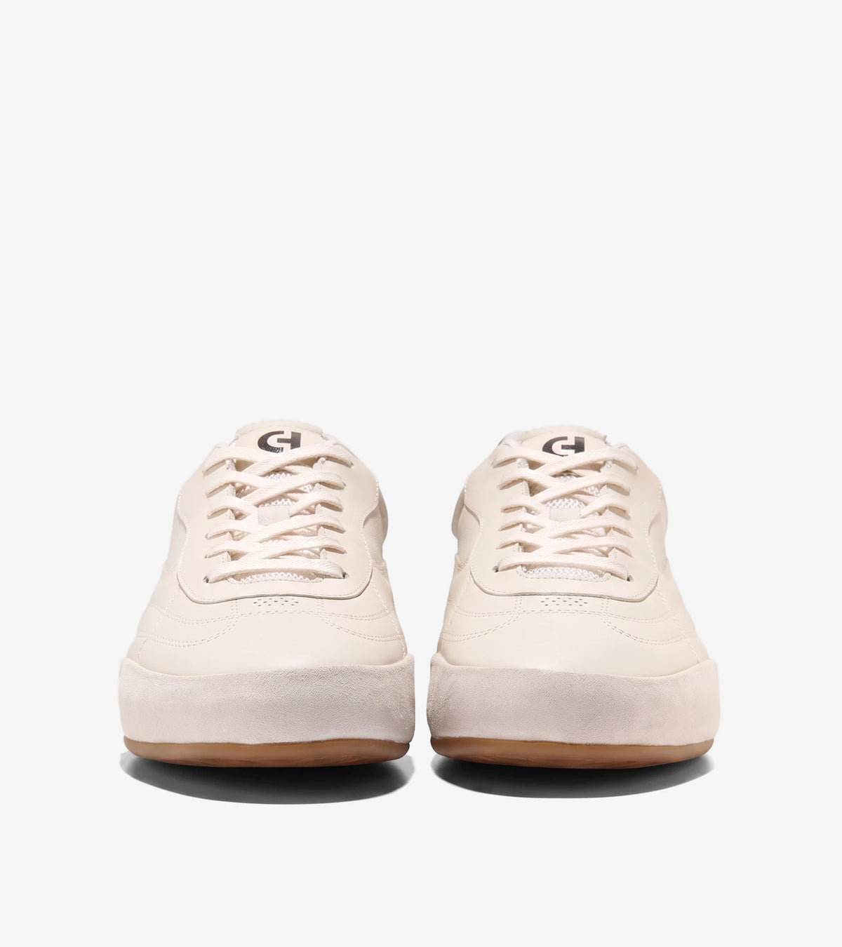 Pair of Grandpro Turf 2.0 sneakers in ivory and silver birch, showcasing a front view of the lace-up design and gum sole.