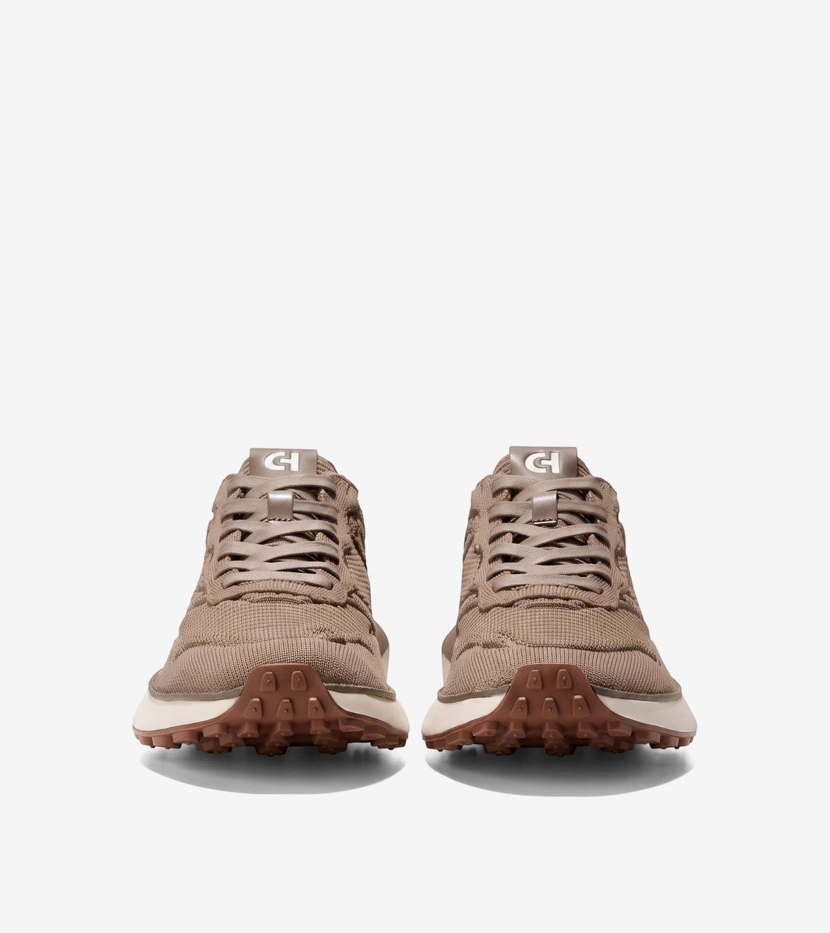Pair of men's beige GrandPrø Ashland Stitchlite™ sneakers, featuring a knit upper and rugged lugged outsole, shown from the