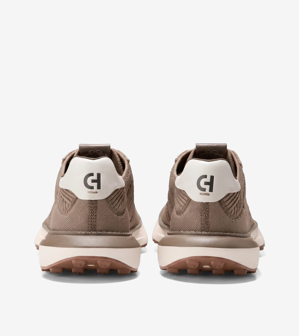 Rear view of Men's GrandPrø Ashland Stitchlite sneakers in a beige knitted material with white heel accents and brown soles.