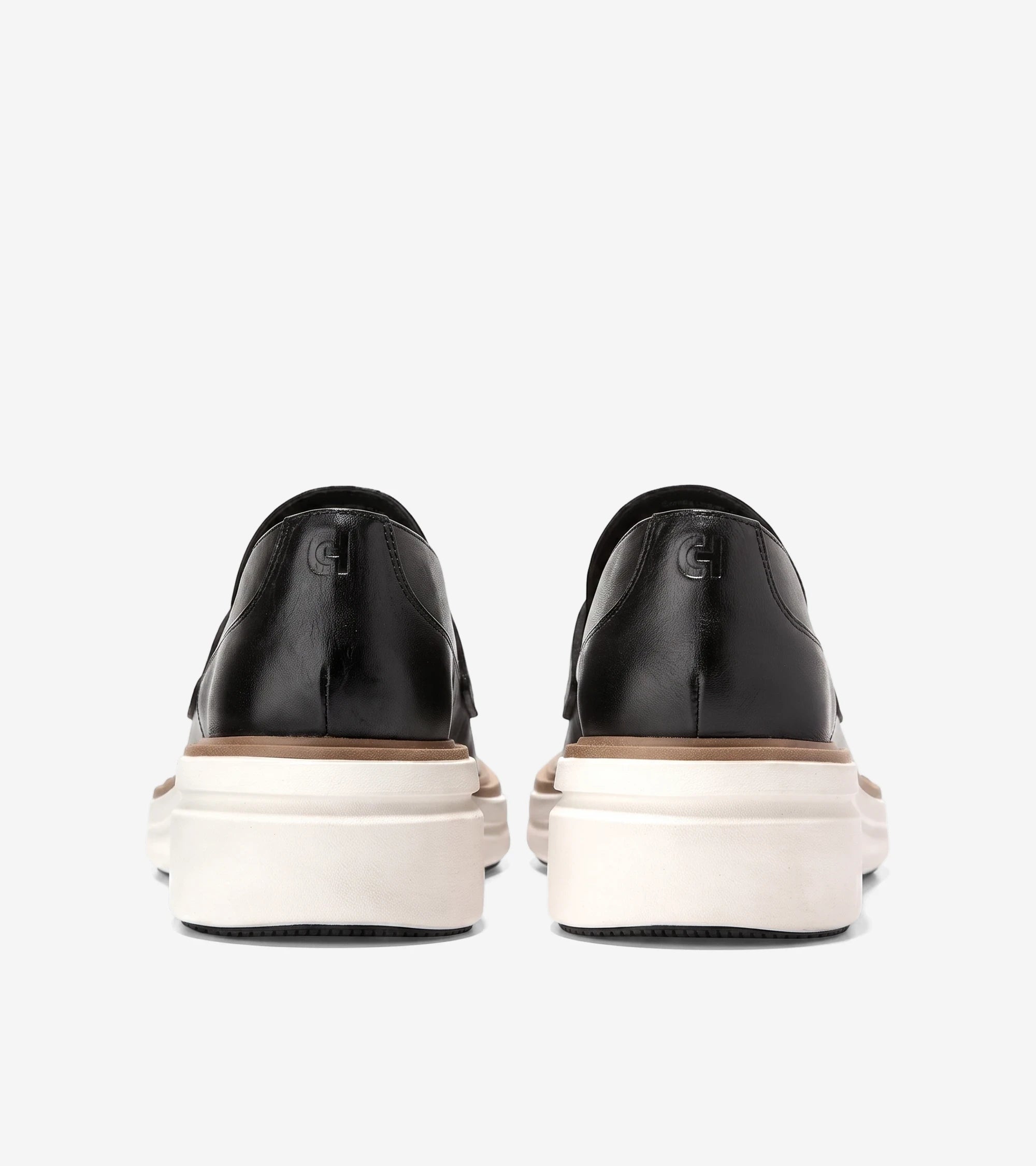 Rear view of women's black leather ØriginalGrand CitySpectre loafers with chunky white and beige platform soles.
